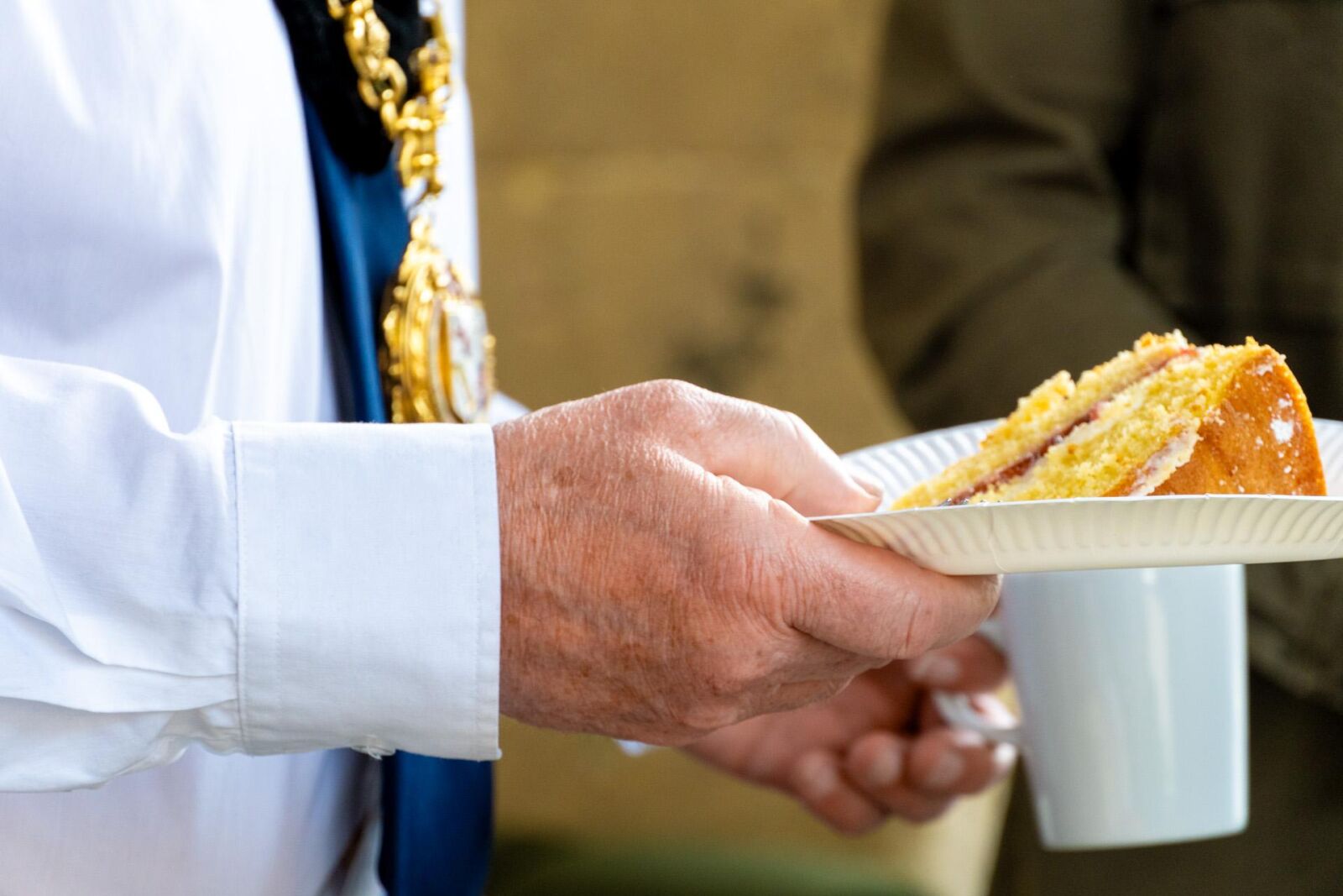 The Mayor holding some cake